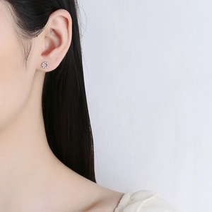925 sterling silver round zircon screw-back stud earring worn on model with gray background