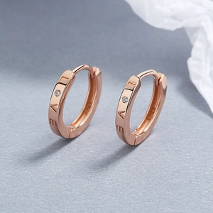 925 silver rose gold LOVE earrings with small crystal inlay on textured background