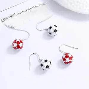Macro shot of 925 silver football earrings with red and black enamel coating detail