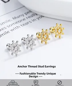 Detailed view of 925 sterling silver anchor earrings with pave-set zircon stones