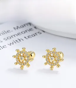 Detailed close-up of 925 sterling silver anchor stud earrings with small white crystals