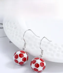 Detailed macro view of S925 sterling silver soccer ball drop earrings with red enamel