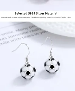 Close-up of S925 sterling silver soccer ball drop earrings with black and white enamel