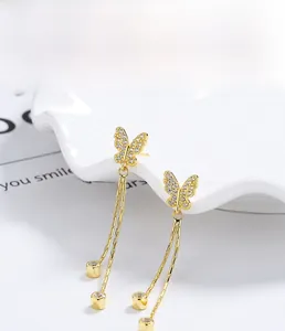 Detail of S925 sterling silver butterfly tassel earrings with gold plating and zircons