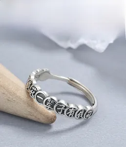 Macro shot of S925 sterling silver coin ring with vintage engraving and texture