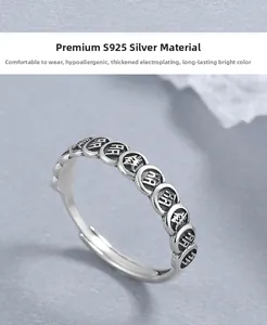 Close-up of vintage S925 silver open ring featuring an engraved coin relief pattern