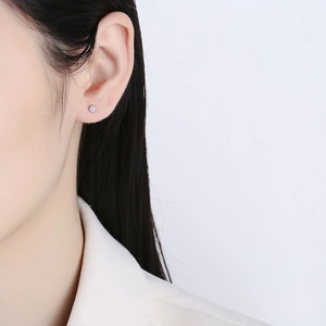 Minimalist 925 sterling silver pearl stud earrings on model for an elegant daily look