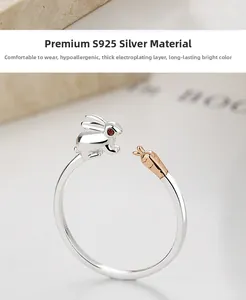 Macro shot of 925 sterling silver rabbit and rose gold carrot on adjustable ring
