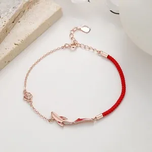 Detail of 925 sterling silver koi fish red braided bracelet with rose gold chain