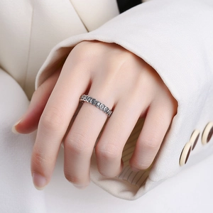 Vintage 925 sterling silver open ring with engraved characters worn on female hand
