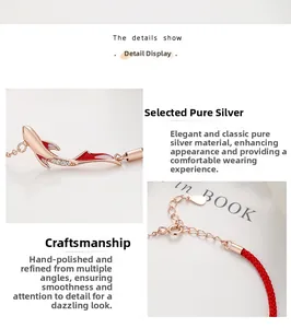 Detail view of 925 sterling silver koi fish charm on red woven braided rope bracelet
