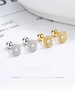 Macro shot of 925 sterling silver pave screw-back stud earrings in gold and silver