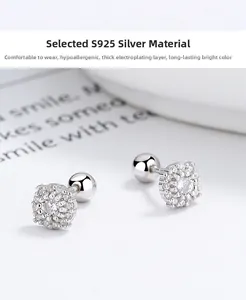 Macro detail of 925 sterling silver screw back earrings with crystal floral studs