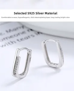 Macro view of S925 sterling silver U-shaped hoop earrings with sparkling paved zircons