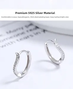 Macro shot of S925 sterling silver S-shaped hoop earrings with zircon stones and thick plating
