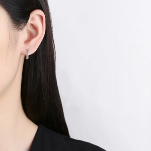 Minimalist 925 sterling silver S-shape earrings with cubic zirconia stones on model