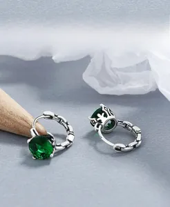 Close-up of S925 sterling silver stamp and emerald green zircon crown setting