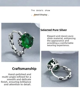 Macro view of S925 sterling silver emerald earrings showing fine engravings and hallmarks