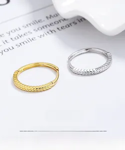 Macro shot of 925 sterling silver wheat ear open rings in gold and silver finish