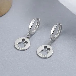 Detail of 925 sterling silver hoop earrings with hollow bunny pendant and Sweet engraving