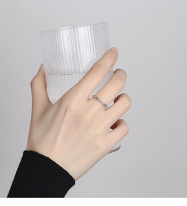 Detail of 925 sterling silver wheat ear ring with intricate textured band on finger