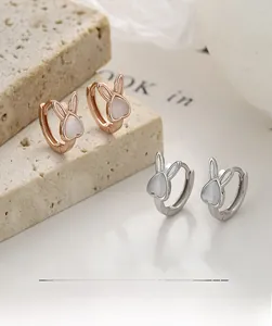 Close-up of S925 sterling silver rabbit earrings with opal stones in rose gold and silver