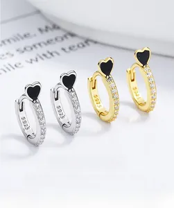 Detailed view of 925 silver heart hoop earrings with sparkling pave zircon settings