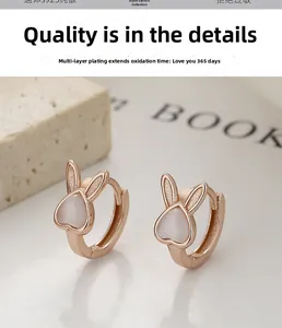 Detail of S925 silver rabbit hoop earrings with heart-shaped cat-eye stone inlay