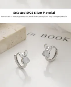 Detailed view of S925 sterling silver rabbit earrings featuring white opal cat eye stones