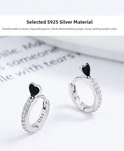 Detailed macro view of S925 sterling silver heart earrings with micro-paved white crystals