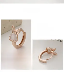 Close-up of S925 sterling silver rabbit earrings featuring heart-shaped opal stone inlay