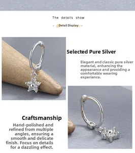 Détail de boucles d'oreilles créoles en argent 925 avec pendentif étoile et zircons polis