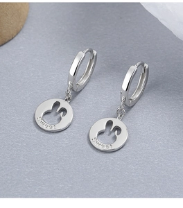 Detail of 925 sterling silver hoop earrings with hollow rabbit disk and Sweet engraving