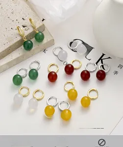 Close-up of S925 sterling silver earrings featuring colorful agate beads and hallmarked clasp