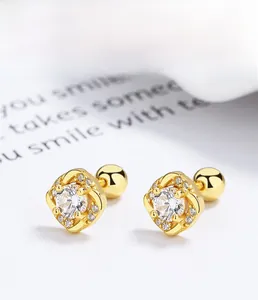 Close-up of gold square stud earrings with zircons and ball screw back closure