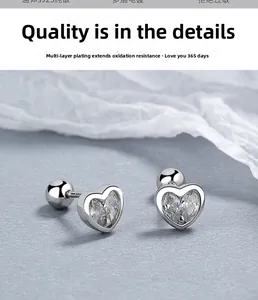 Macro detail of S925 sterling silver heart earrings with white cubic zirconia and screw back