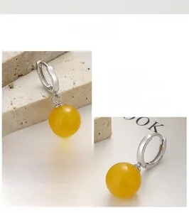 Detail view of S925 sterling silver hoop earrings with polished yellow agate beads