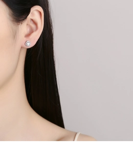 Close-up of 925 silver square zircon screw back stud earring worn on model's ear
