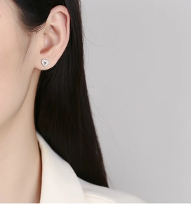 Close-up of S925 sterling silver hollow heart stud earring with micro-pave cubic zirconia