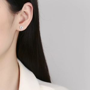 925 sterling silver hollow heart stud earrings with sparkling zirconia on female ear