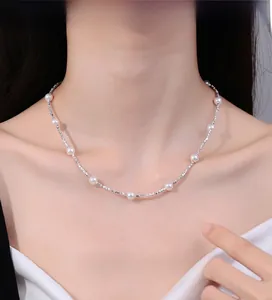Detailed view of 925 sterling silver chain with elegant white round pearls on the neck