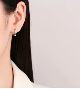 Close-up of minimalist S925 sterling silver hoop earrings with micro-pave white zircons