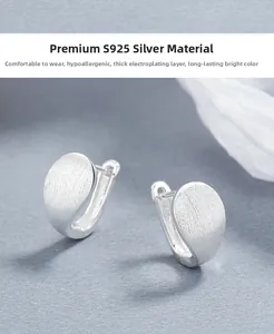Macro shot of 925 sterling silver hoop earrings with a textured brushed metal finish