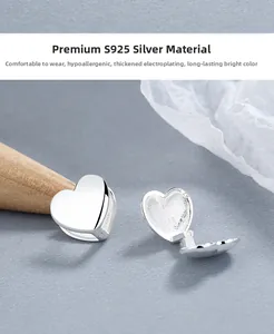 Macro shot of S925 sterling silver heart earring showing the engraved hallmark detail