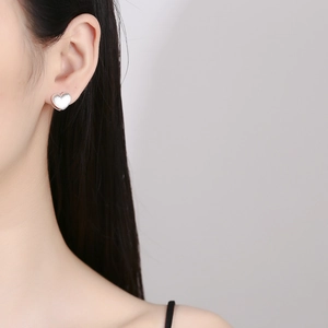 925 Sterling Silver double-layered frosted heart stud earrings on model's ear