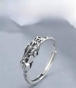 Macro shot of S925 sterling silver PiXiu ring with vintage oxidation and engraved details