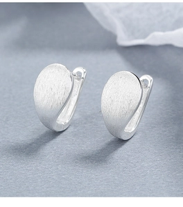 Close-up of teardrop 925 sterling silver earrings with a fine brushed matte texture finish