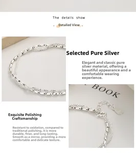 Detail of 925 sterling silver double-layer bracelet featuring silver beads and rope chain