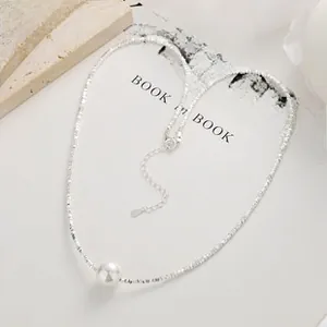 Macro detail of 925 silver chain with natural freshwater pearl on aesthetic prop