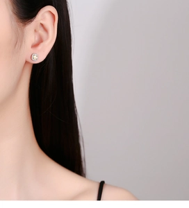 Close-up of square 925 sterling silver stud earring with yellow zircon and halo crystals